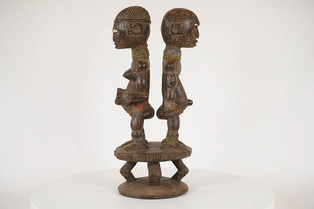Nigerian Male and Female Figure - African Tribal Art Sculpture: Measurements (inches) & Weight (pounds) Height: 18" Width: 8" Depth: 7" Weight: 7.5 lbs An interesting figure featuring a male and female statue standing back to back on top of an elevated platfor
