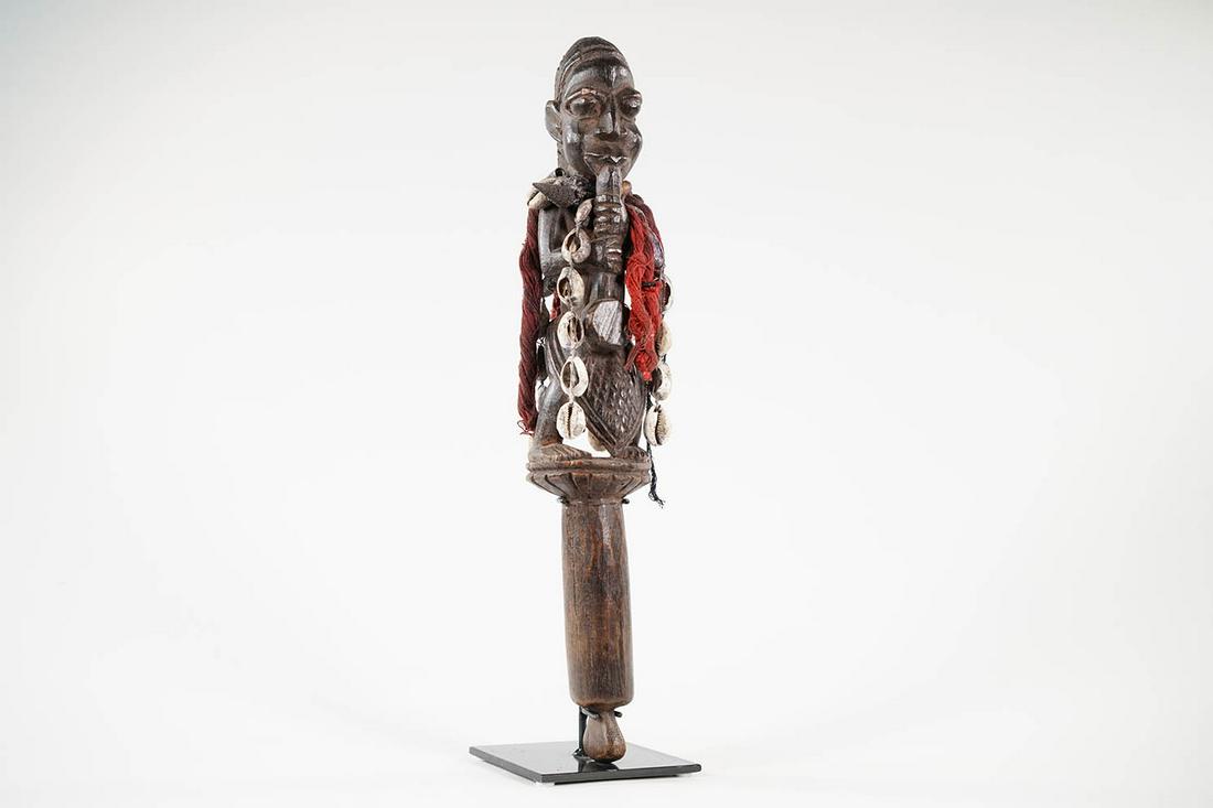 Yoruba Staff on Base from Nigeria - African Tribal Art Sculpture: Measurements (inches) & Weight (pounds) Height: 17" Width: 4" Depth: 4" Weight: 2 lbs Yoruba staff adorned with shells and fiber accoutrements, attached to base.