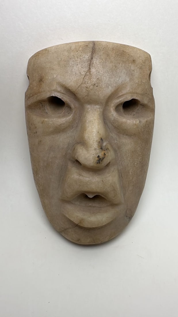 PRE-COLUMBIAN OLMEC ALABASTER PECTORAL MASK: PRE-COLUMBIAN OLMEC ALABASTER PECTORAL MASKElegant Olmec alabaster pectoral mask, dating approximately 1200 BC – 400 BC (Formative Period), representing the refined sculptural tradition of one of Me