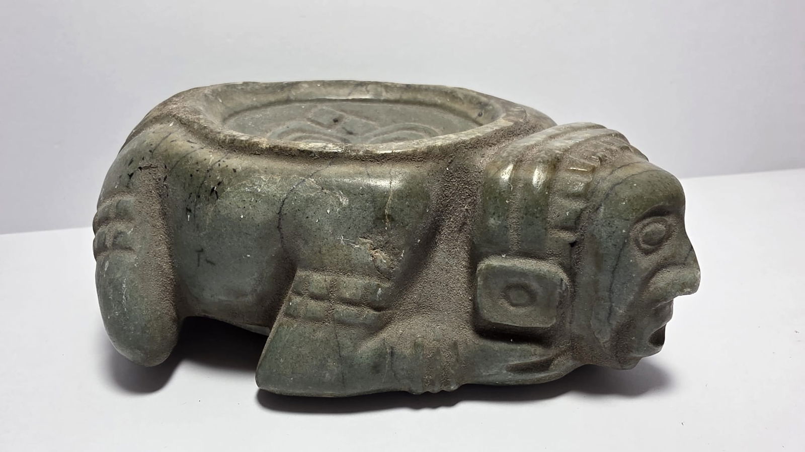 PRE-COLUMBIAN AZTEC JADE AUTOSACRIFICE CONTAINER WITH TLALOC GLYPH: PRE-COLUMBIAN AZTEC JADE AUTOSACRIFICE CONTAINER WITH TLALOC GLYPHRare Aztec jade ceremonial container associated with autosacrifice rituals, carved with the glyph of Tlaloc, the powerful God of Rain,