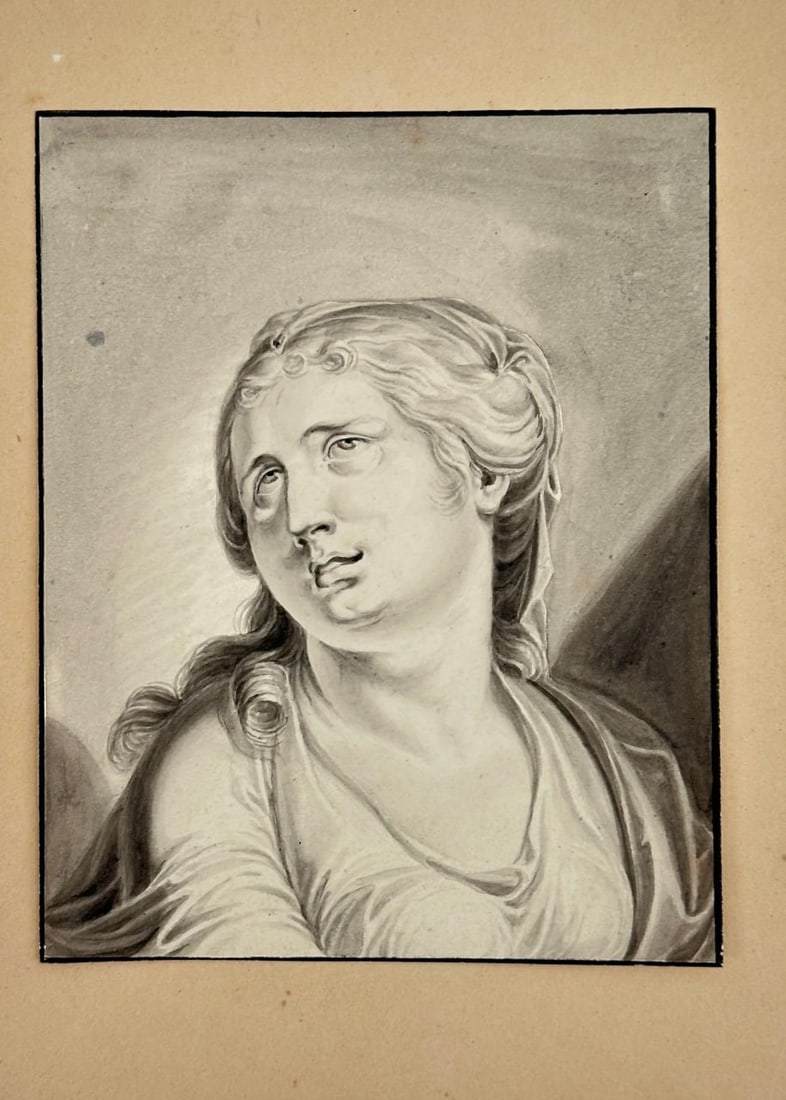 Unknown Artist – Portrait of a Woman in Classical Style – Original Drawing (19th Century): This beautifully rendered drawing portrays a woman in classical attire, gazing upwards with an expression of serenity and grace. The artist skillfully employed chiaroscuro techniques, using light and 