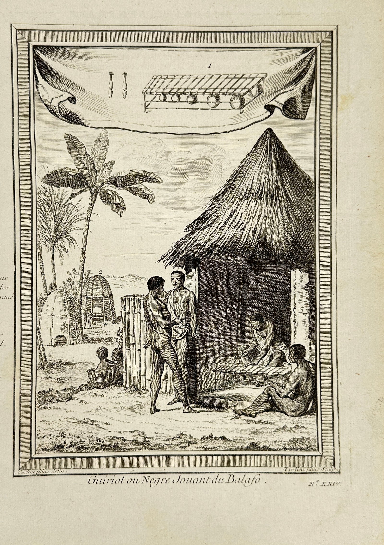 Antoine-François Prévost d’Exiles – Guiriot ou Nègre Jouant du Balafon – Original Engraving: This original 18th-century ethnographic engraving shows a West African musician playing the balafon, a traditional xylophone-like instrument, in a village setting. Titled Guiriot ou Nègre Jouant du B