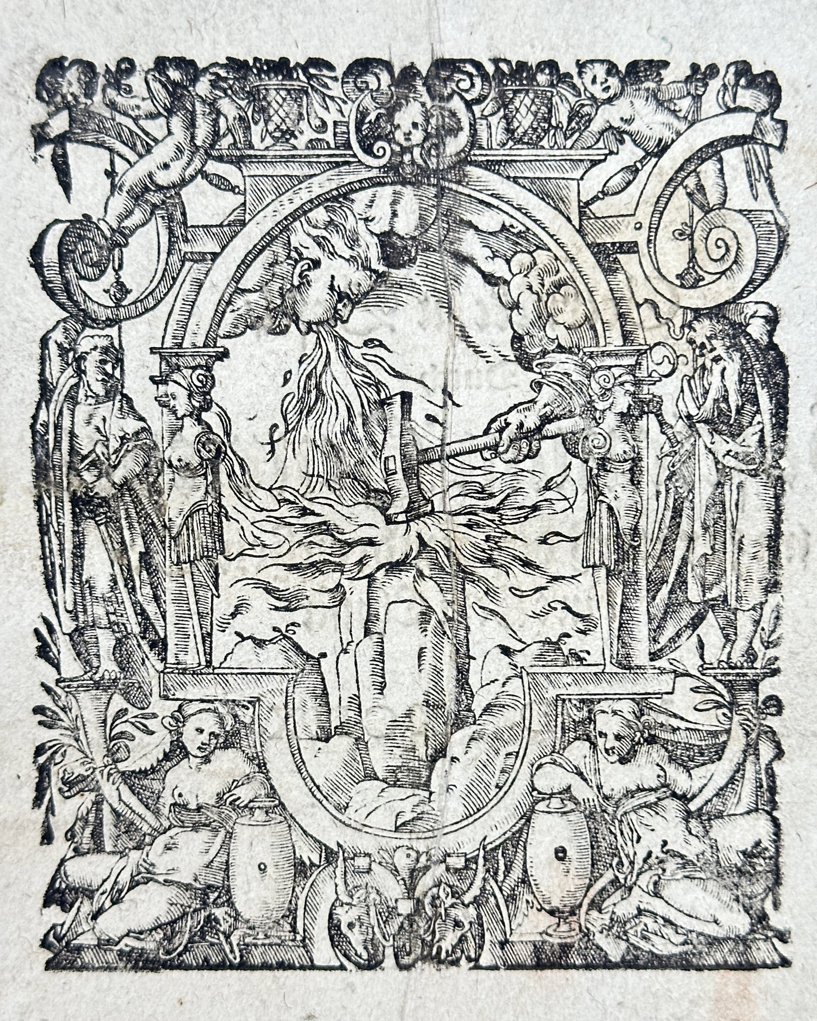 Sebastian Henricpetri (1546–1627) – Allegorical Initial Letter L (Pyre, Figures, and Putti) –: This print is an exceptionally large and ornate woodcut initial letter L, designed as a richly detailed Renaissance architectural cartouche. The composition is highly symbolic, featuring a blazing fir