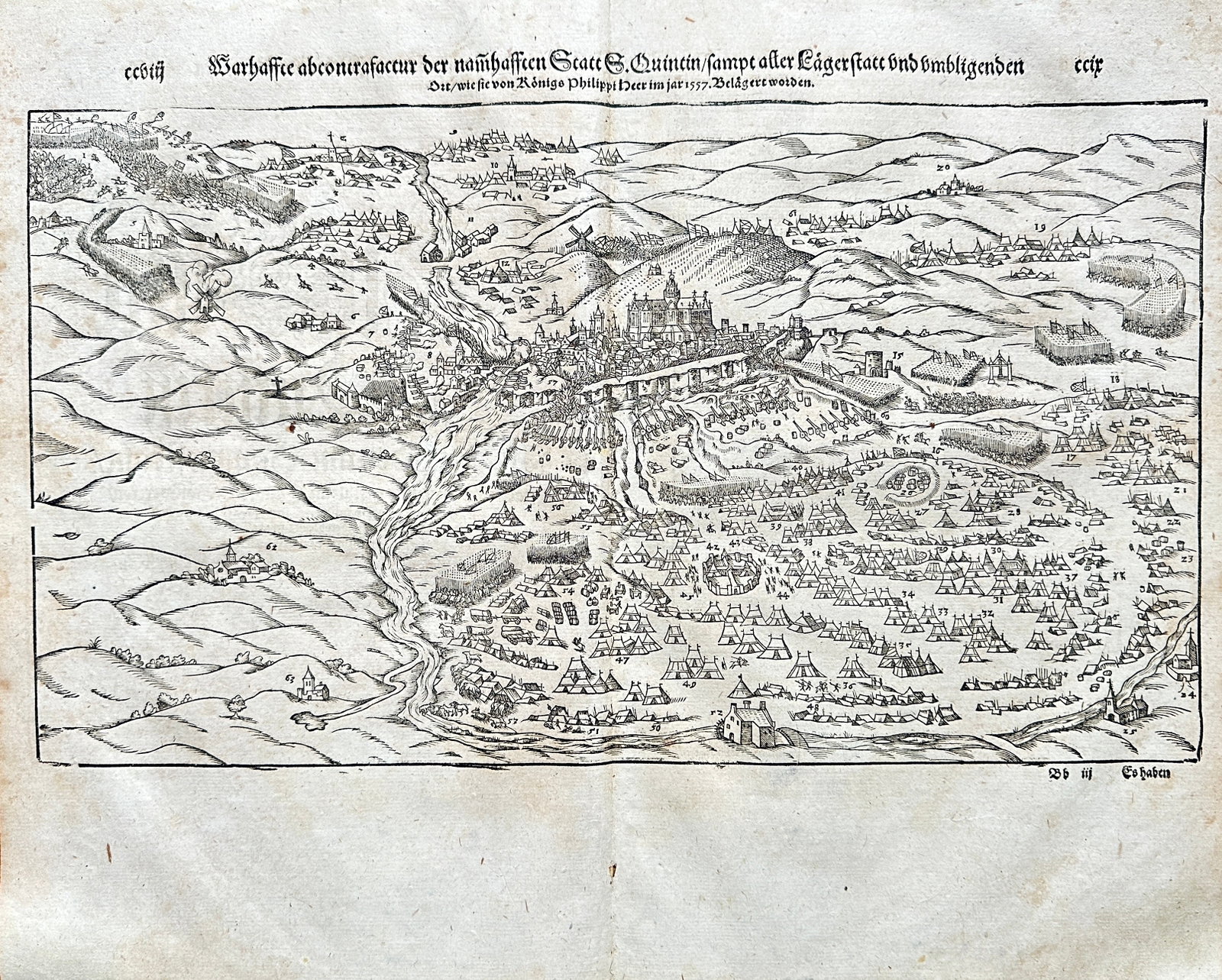 Sebastian Münster (1488-1552) – True Portrait of the famous City of St. Quentin: A dramatic, historical topographical woodcut map providing a bird's-eye view and military plan of the city of Saint-Quentin, France. The detailed scene captures the city nestled on a prominent hill, s