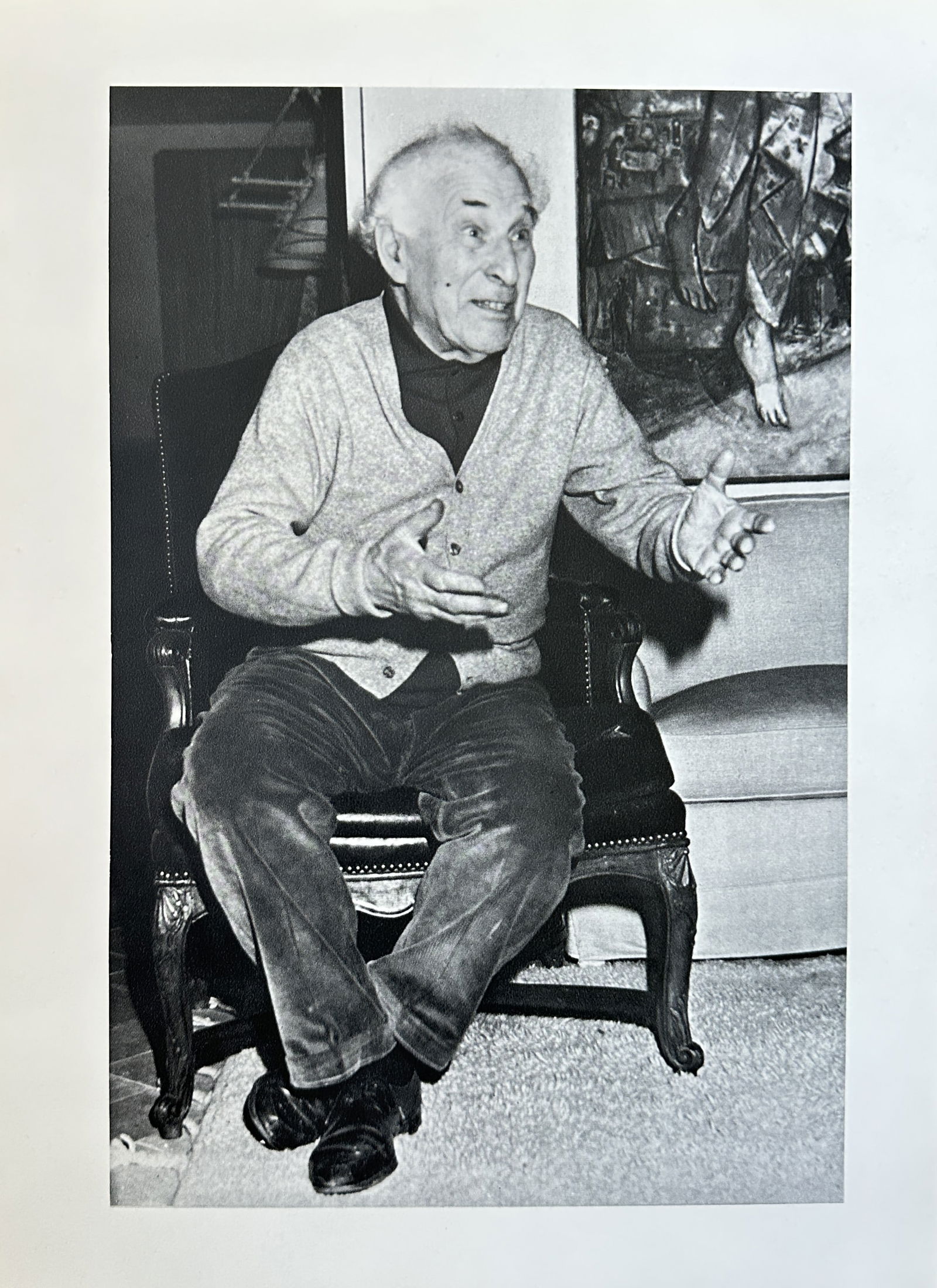 Marc Chagall, after – Portrait of the Artist in a Chair – Offset print (20th Century): This black and white offset print features a photographic portrait of the renowned artist Marc Chagall seated in an armchair. The artist is captured in a casual, expressive posture, gesturing with his