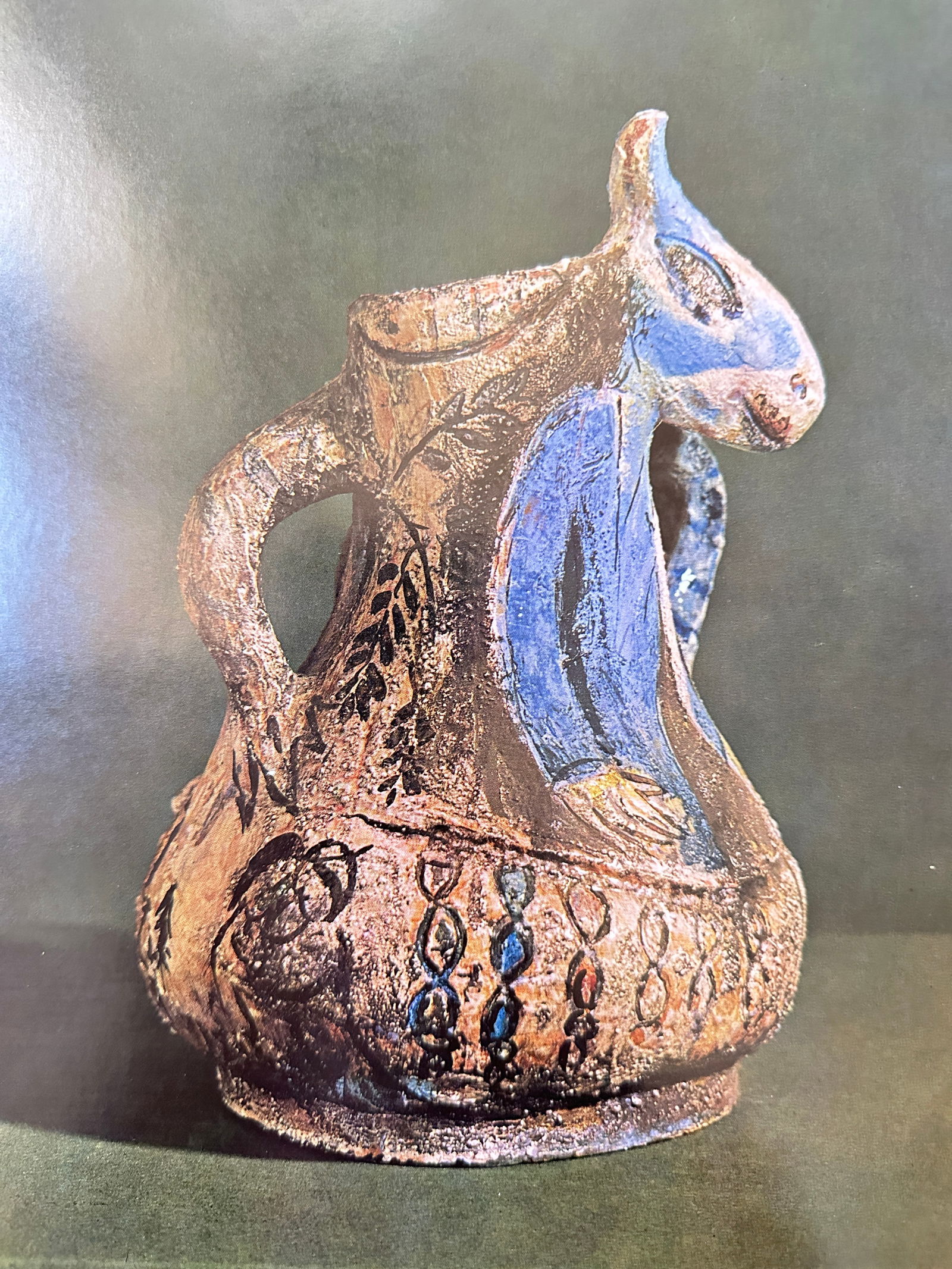 Marc Chagall, after – The Blue Donkey – Offset print (20th Century): This offset print showcases a photograph of a three-dimensional ceramic object created by Chagall. The object, titled The Blue Donkey, is a stylized, hand-modeled ceramic vase or pitcher shaped like a