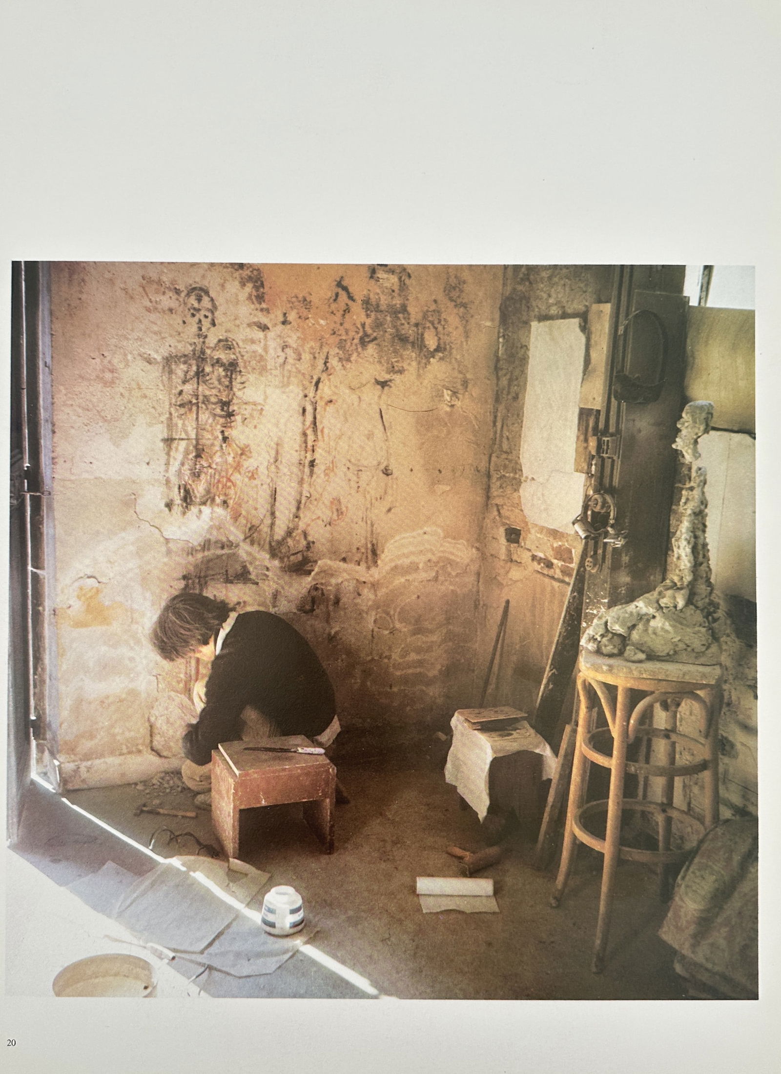 Alberto Giacometti Studio – Alberto Giacometti Working in His Studio – Offset print (20th: This Offset print is a color photographic depicting Alberto Giacometti (1901–1966) working in his famously small and chaotic Paris studio at 46 rue Hippolyte-Maindron. The artist is shown bent over