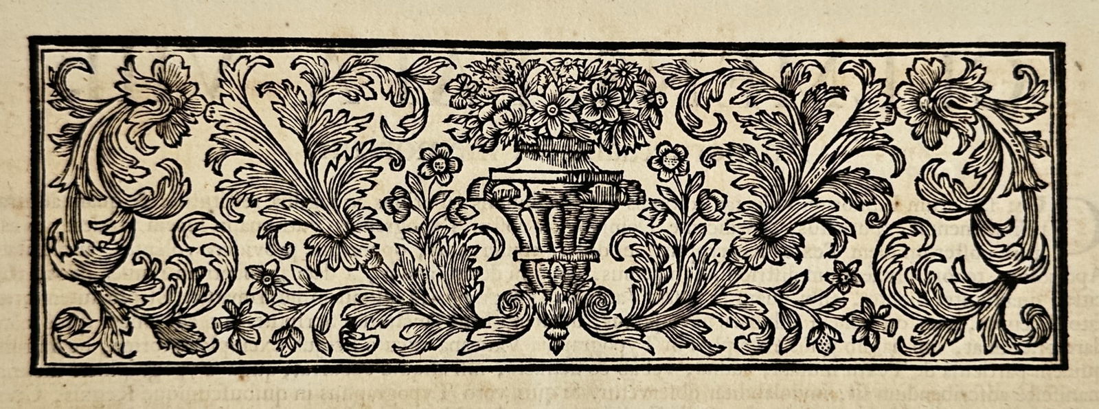 Unknown Artist (17th Century) – Vertical Ornamental Panel with Vase and Foliage – Woodcut (1634): "Somnium." illustrates an elongated vertical decorative border or headpiece featuring a central urn filled with a dense bouquet of flowers. The composition is symmetrically balanced by elaborate acant