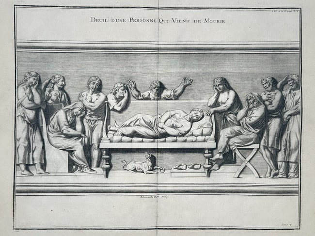 Bernard De Montfaucon (1655-1741) – Mourning for a Deceased Person – Engraving (1719): "Deuil d'une Personne qui vient de Mourir" This engraving depicts a classical Roman funerary scene based on ancient relief sculpture. The central focus is a deceased figure lying upon an elevated cere