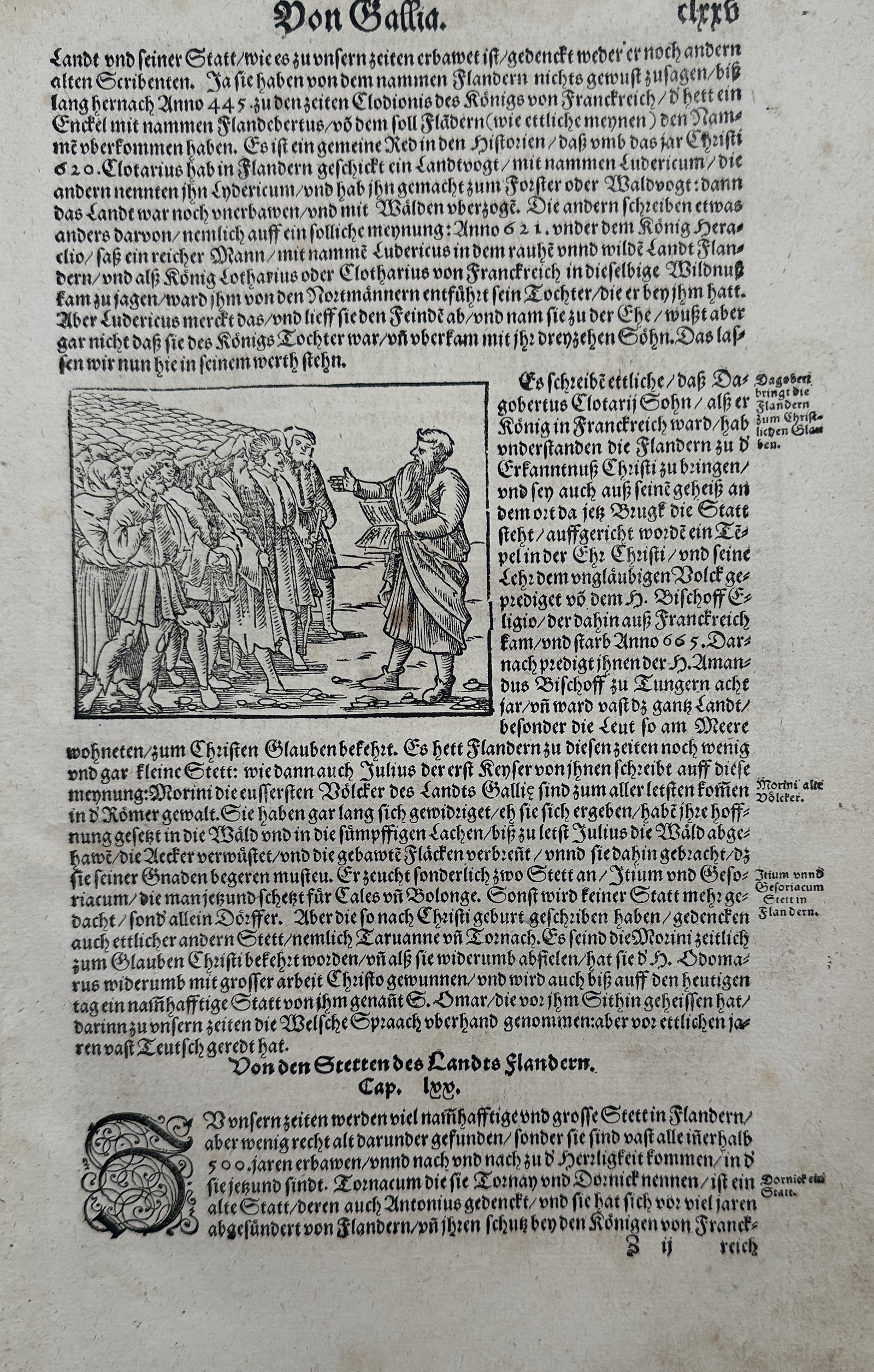 Sebastian Münster (1488–1552) – View of a Preacher Addressing a Crowd – Woodcut (1550): "Von Gallia." This woodcut illustrates a preacher holding an open book and addressing a group of men and women in an outdoor setting, set within a page of German text discussing the history of Flander