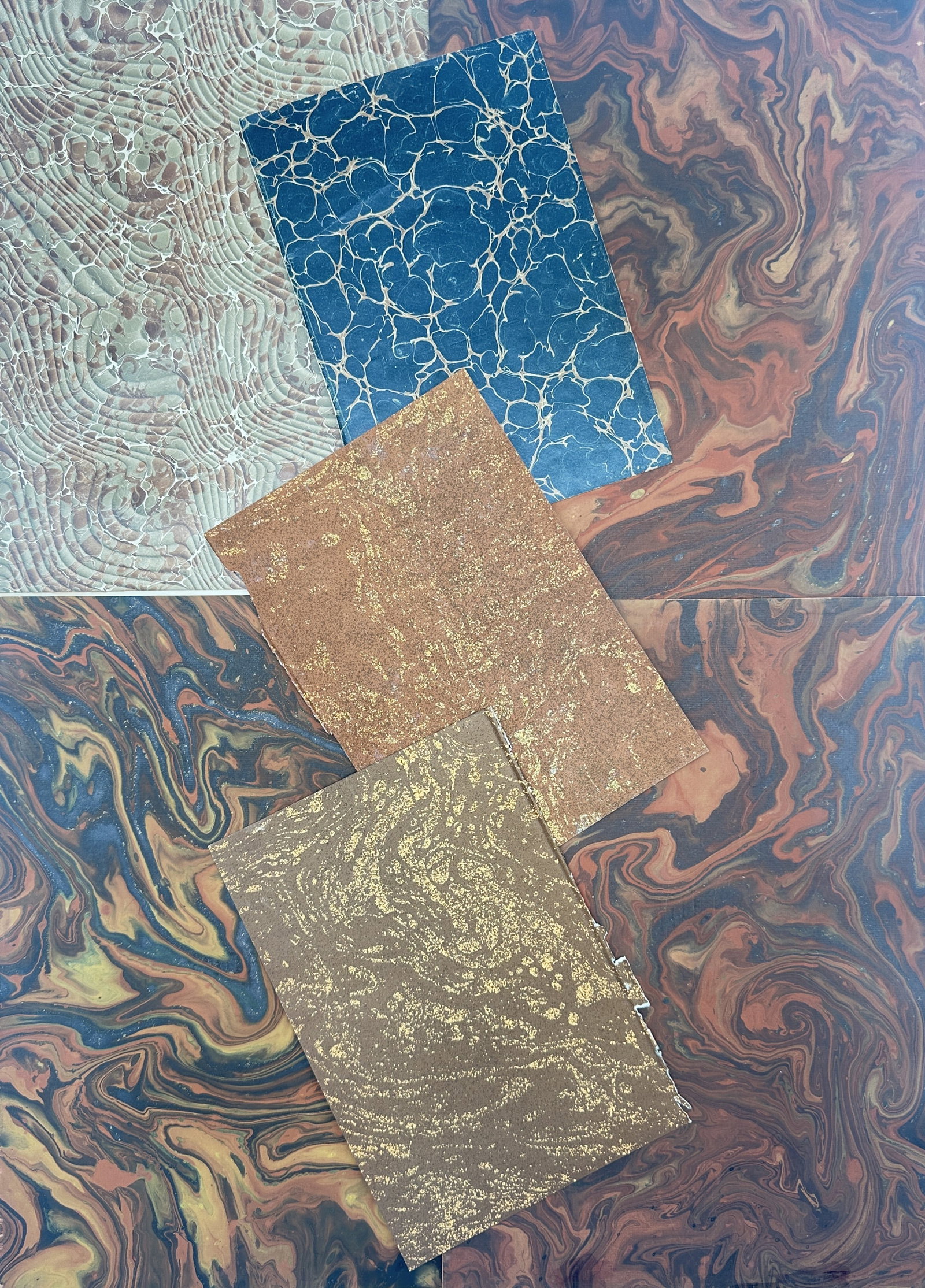 Unknown Artist – Set of 7: Antique Marbled Paper Sheets and Bookbinding Endpapers: "Marbled Paper Collection" depicts a broad overview of decorative bookbinding elements, including swirling organic fluid patterns, concentric comb textures, vibrant deep blue stone veins, and golden f