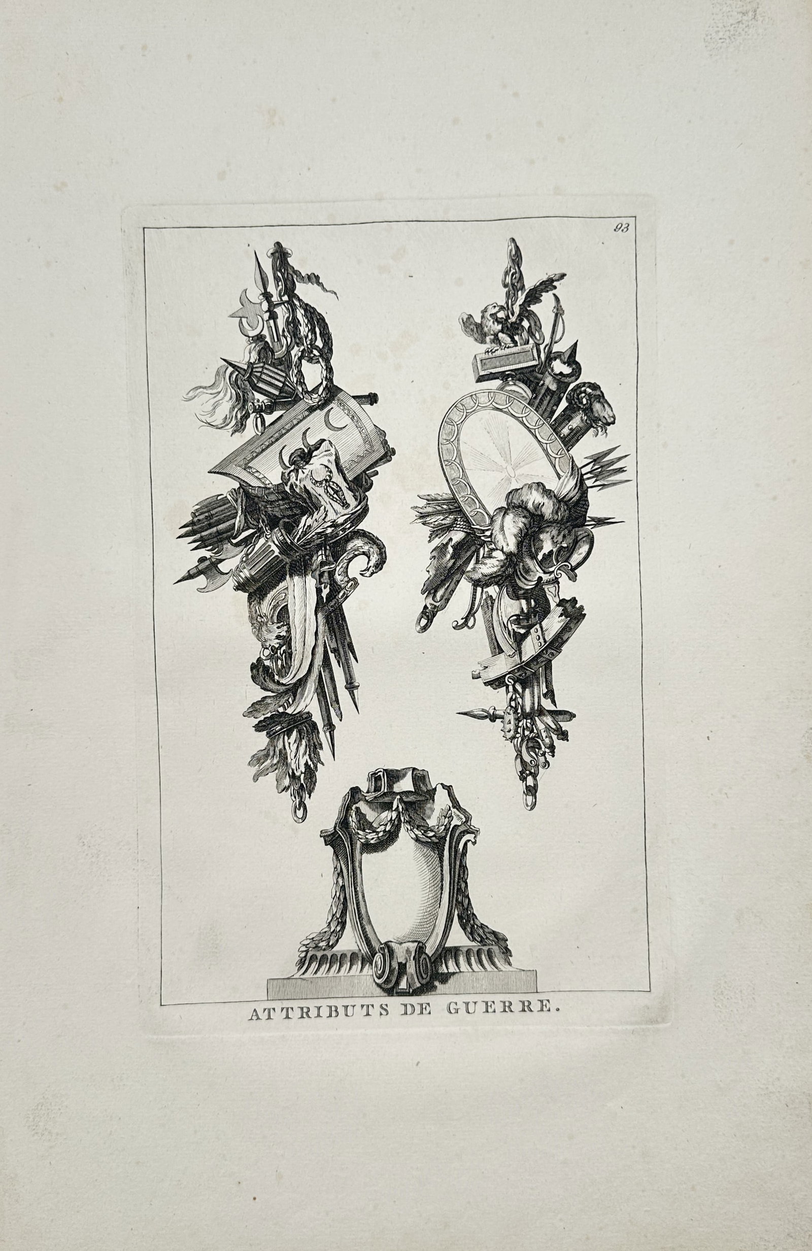 Jean-Charles Delafosse – Attributes of War – Engraving (18th Century): "Attributes of War" depicts decorative military trophies, weapons, shields, and an ornamental pedestal motif arranged within a rectangular frame. The artwork serves as an architectural and decorative 
