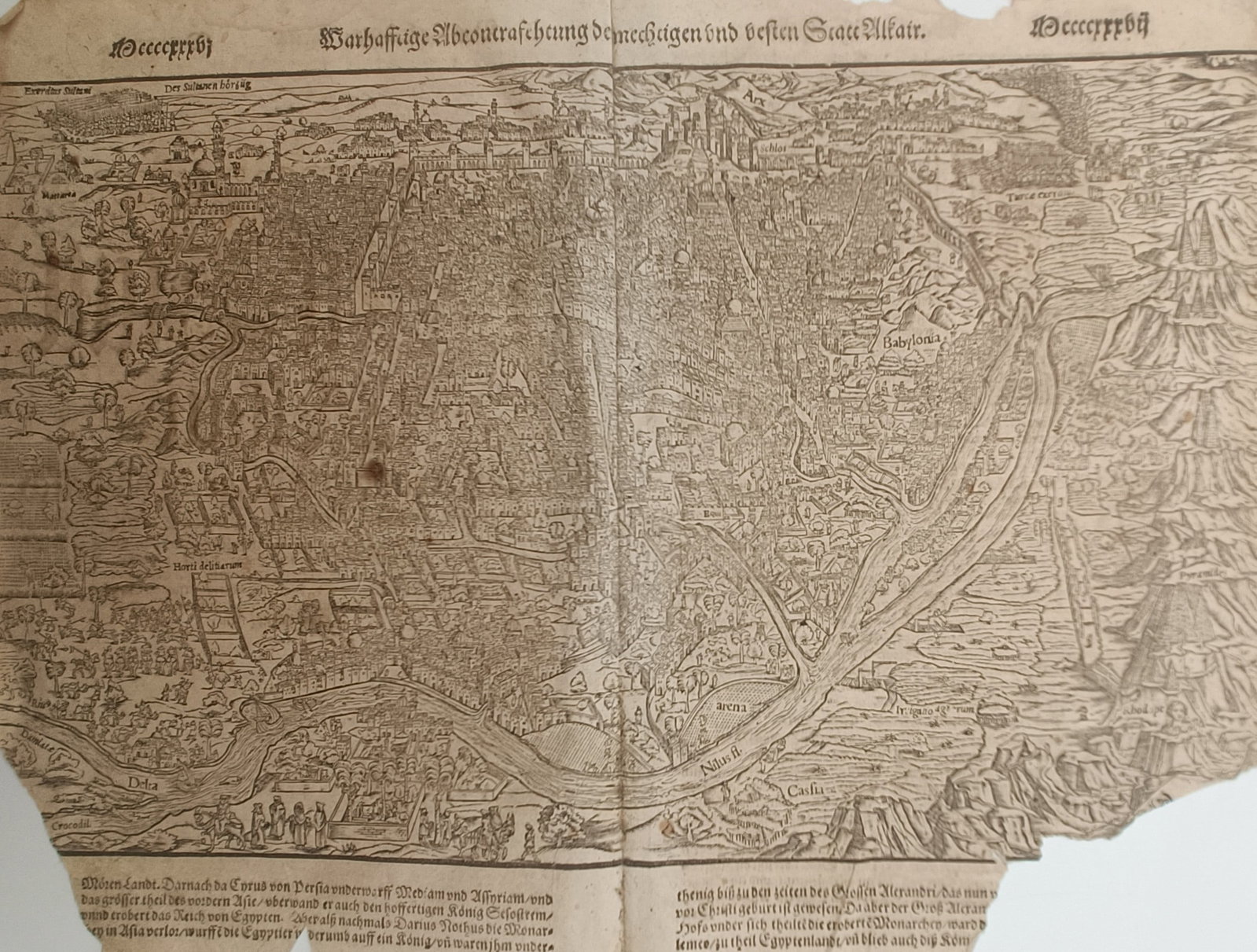 Sebastian Münster – Map of Cairo – Egypt – Woodcut (16th Century): "True Depiction of the Mighty and Great City of Cairo" presents a panoramic bird's-eye view depicting the urban sprawl, major architectural monuments, and the winding course of the Nile River. The com
