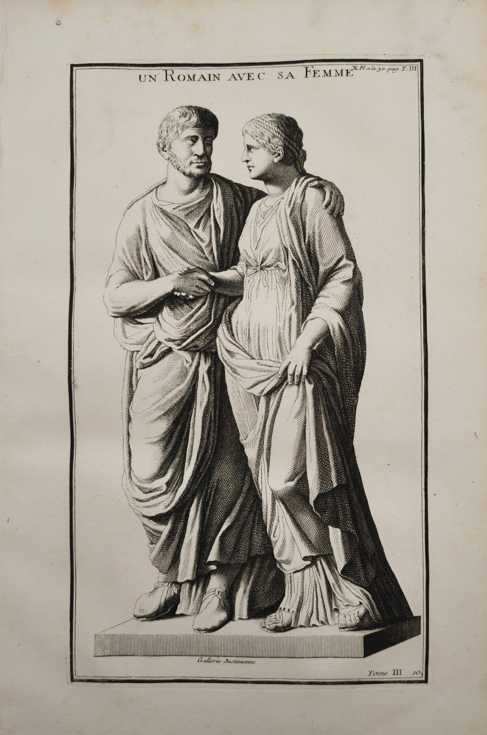Bernard de Montfaucon – A Roman with His Wife – Engraving (18th Century): "A Roman with His Wife" presents an archaeological study illustrating an ancient Roman sculptural monument depicting a married couple in classical drapery joining hands in a ceremonial gesture of unio