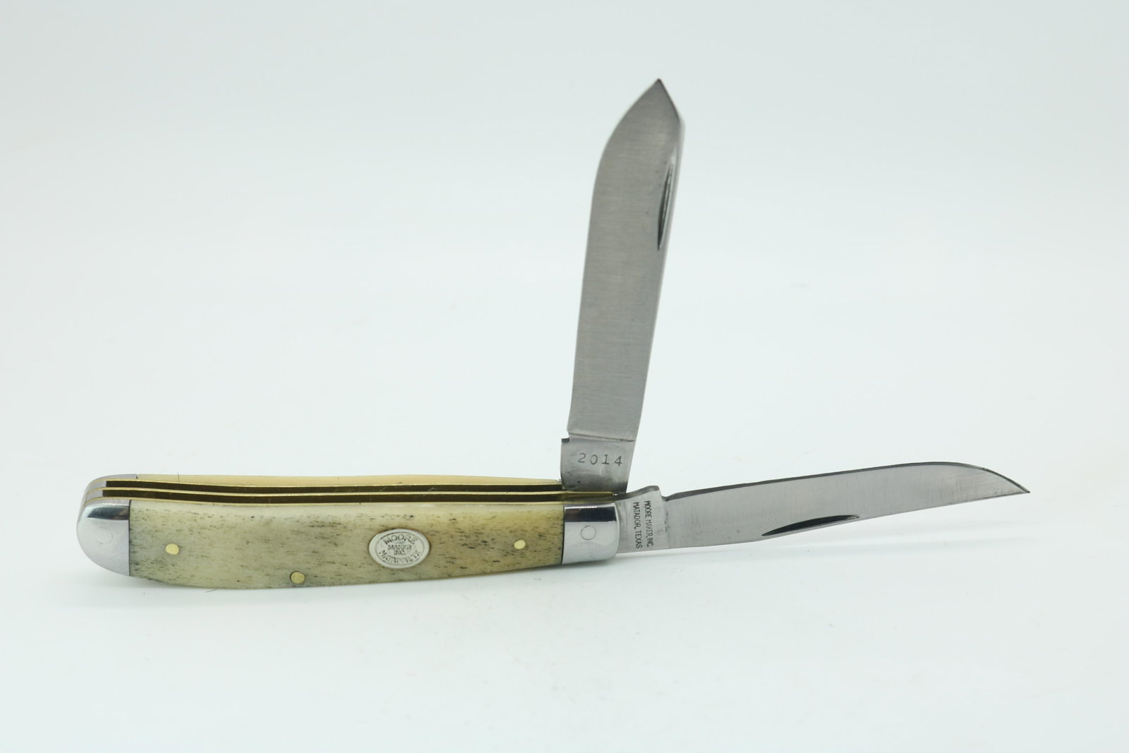 Moore Maker 5200 Mini Trapper 2-Bladed Folding Knife: Smooth White Bone - Blades centered well - no wobble, good snap - gap between liners/spring - you can see eyes in the bolsters - 3-1/2" long when shut - Made by Queen Cutlery