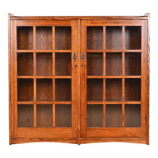 Stickley Style Mission Oak Arts and Crafts Double Bookcase: A beautiful Mission oak Arts & Crafts bookcase cabinet In the manner of Stickley USA, Late 20th Century Solid oak, with mullioned glass front doors, and original hardware. Cabinets lock, and key is in