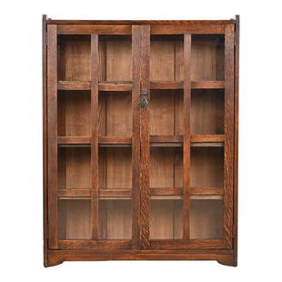Stickley Brothers Mission Oak Arts and Crafts Bookcase, Circa 1900: A gorgeous antique Mission or Arts & Crafts bookcase cabinet By Stickley Brothers USA, Circa 1900 Quarter sawn oak, with mullioned glass front doors, and original copper hardware. Cabinet locks, and k