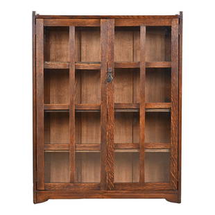 Stickley Brothers Mission Oak Arts and Crafts Bookcase, Circa 1900: A gorgeous antique Mission or Arts & Crafts bookcase cabinetBy Stickley BrothersUSA, Circa 1900Quarter sawn oak, with mullioned glass front doors, and original copper hardware. Cabinet locks, and key