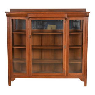 Stickley Brothers Mission Oak Arts and Crafts Bookcase, Circa 1900: A gorgeous antique Mission or Arts & Crafts bookcase or display cabinetBy Stickley BrothersUSA, Circa 1900Carved quarter sawn oak, with glass front doors and sides, mirrored back on top shelf, and