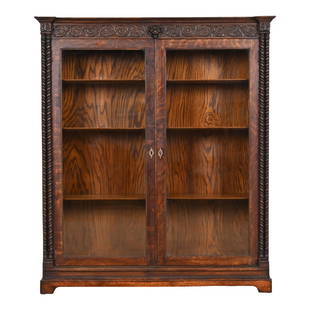R. J. Horner Style American Empire Carved Oak Double Bookcase, Circa 1890: A gorgeous antique American Empire or late Victorian double bookcase In the manner of R.J. Horner USA, Circa 1890 Beautiful quarter sawn oak, with carved lion head and foliage, glass front doors, and