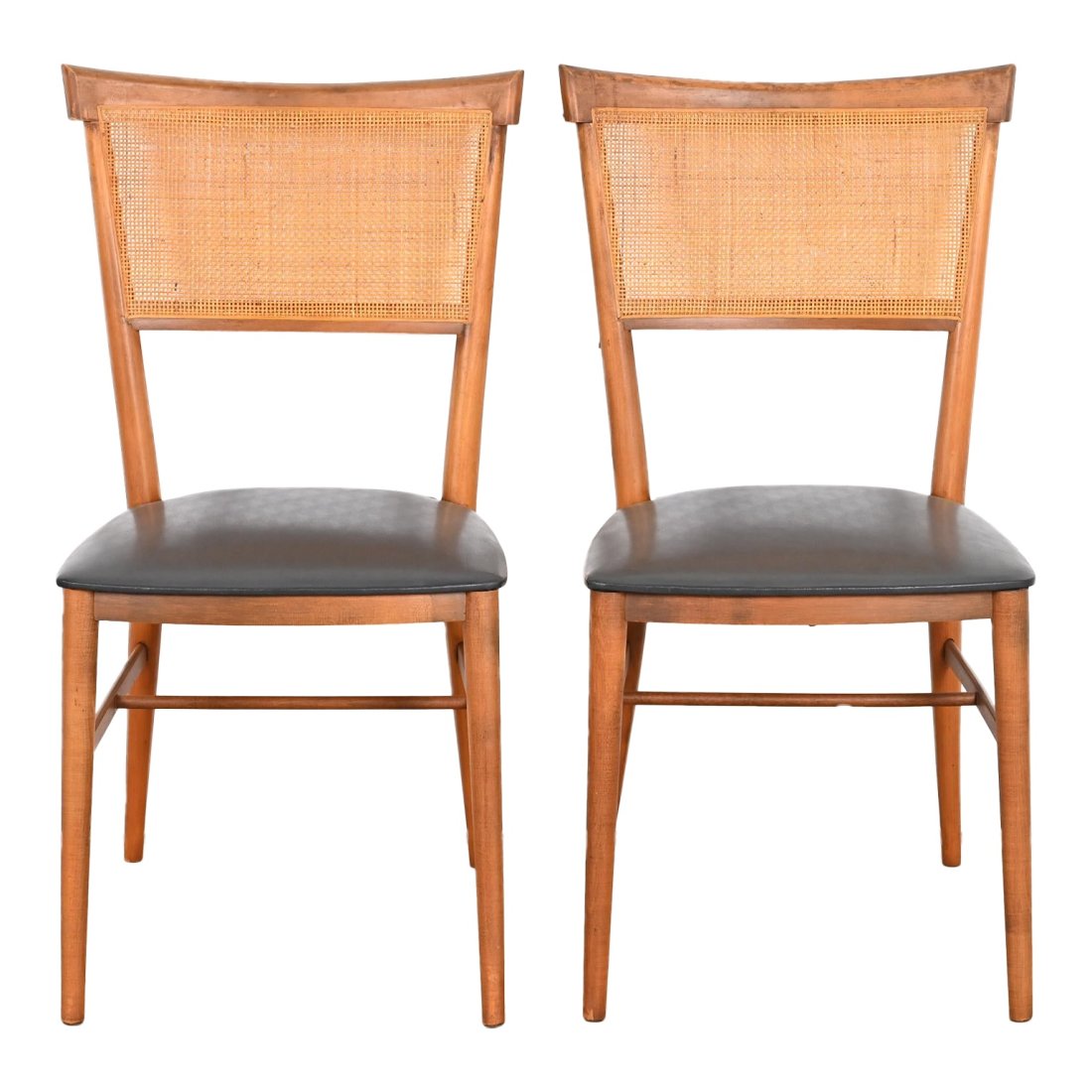 Paul McCobb Planner Group Mid-Century Modern Dining Chairs or Side Chairs, Pair: A sleek and stylish pair of Mid-Century Modern side chairs or dining chairs By Paul McCobb for Winchendon Furniture, "Planner Group" USA, 1950s Sculpted solid birch, with caned backs and black vinyl u