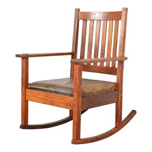 Stickley Brothers Antique Mission Oak Arts & Crafts Rocking Chair, Circa 1900: A gorgeous Mission oak Arts & Crafts rockerBy Stickley BrothersUSA, Circa 1900Solid quarter sawn oak, with original olive green leather seat.Measures: 25.25"W x 27.5"D x 34.5"H. Seat height: 15". Arm