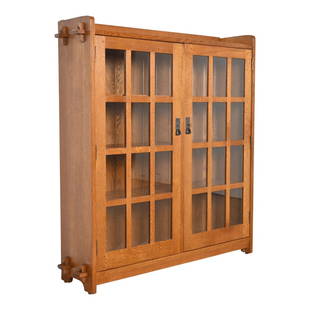 Stickley Mission Oak Arts and Crafts Bookcase Cabinet: A beautiful Mission oak Arts & Crafts bookcase cabinet By L. & J.G. Stickley USA, 1990s Solid quarter sawn oak, with mullioned glass front doors, and hammered copper hardware. Doors lock, and key is i