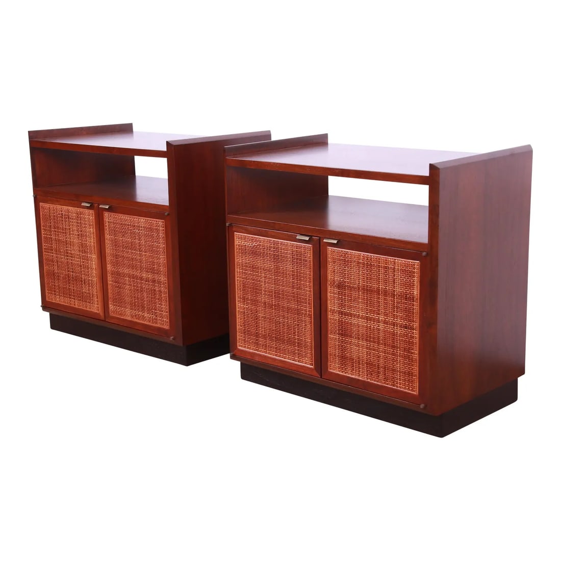 Jack Cartwright for Founders Walnut and Cane Nightstands, Newly Refinished: A gorgeous pair of mid-century cabinets or nightstands By Jack Cartwright for Founders USA, 1960s Walnut, with woven rattan door fronts, black lacquered plinth base, and original brass hardware. Measu