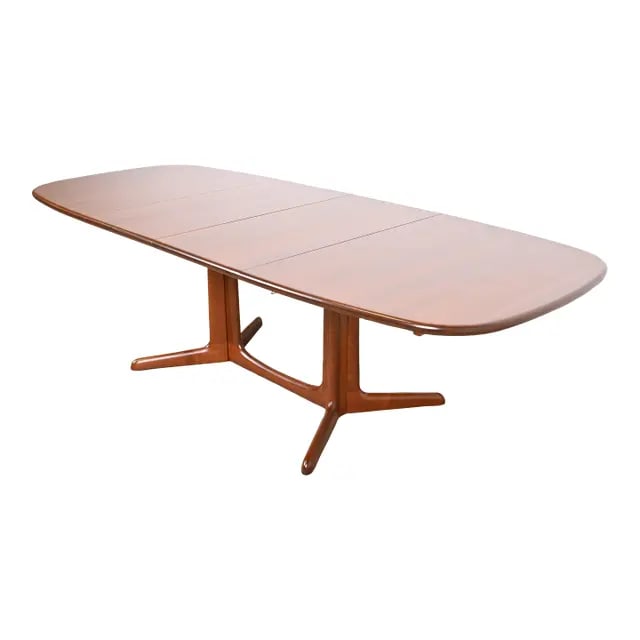 Niels Moller for Gudme Mobelfabrik Danish Modern Sculpted Teak Extension Dining Table: A sleek and stylish mid-century Danish Modern sculpted teak extension dining table By Niels Moller for Gudme Mobelfabrik Denmark, Circa 1960s Measures: 63.5"W x 41.5"D x 28.75"H. Extends up to 101.5"W