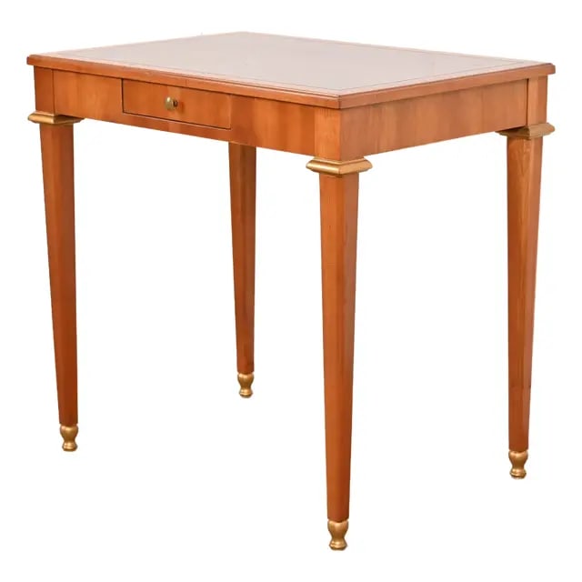 Baker Furniture French Regency Louis XVI Cherry and Gilt Wood Petite Writing Desk or Entry Table: A gorgeous French Regency Louis XVI style petite writing desk, console table, or tea table By Baker Furniture USA, Circa 1960s Carved cherry wood, with gold gilt accents, and original brass hardware.