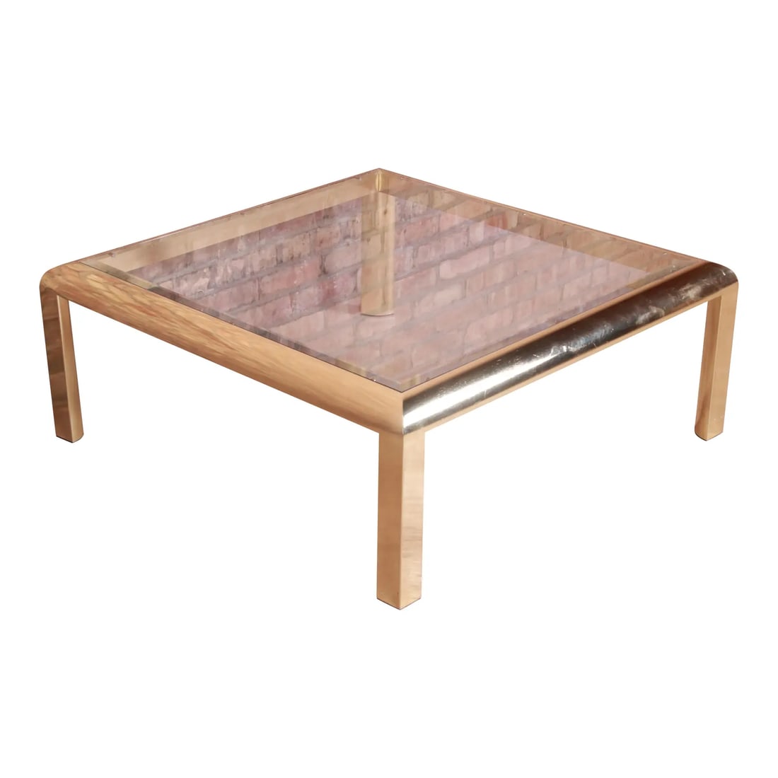 Design Institute of America Modern Hollywood Regency Brass & Glass Cocktail Table, 1984: A gorgeous Milo Baughman style modern Hollywood Regency coffee or cocktail table By the Design Institute of America USA, 1984 Brass frame with beveled glass top. Measures: 38.5"W x 38.5"D x 15"H. Good