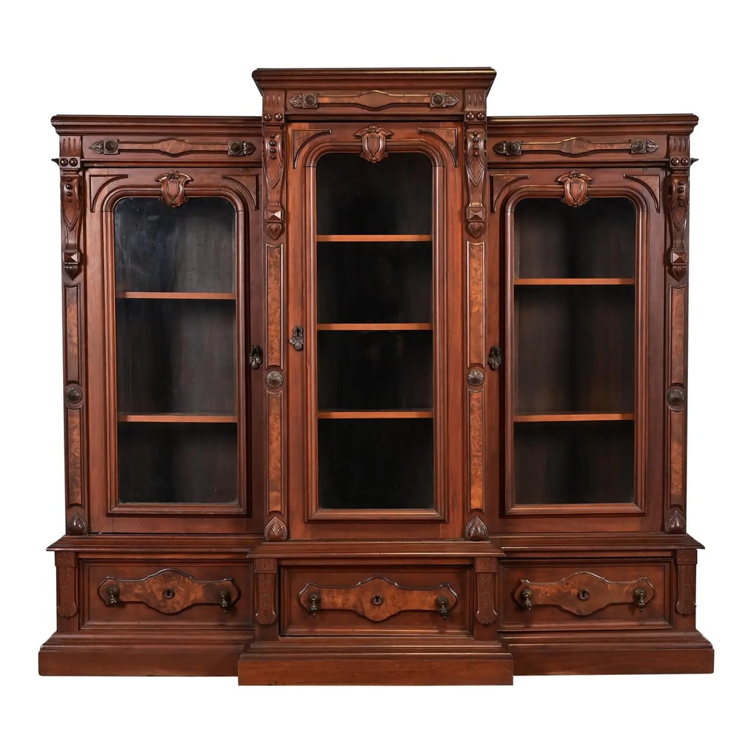 Herter Brothers Style Antique Eastlake Victorian Carved Walnut and Burl Wood Triple Bookcase: A gorgeous antique Eastlake Victorian or Renaissance Revival triple bookcase cabinet or display cabinet In the manner of Herter Brothers USA, Late 19th Century Carved walnut and burl wood, with glass