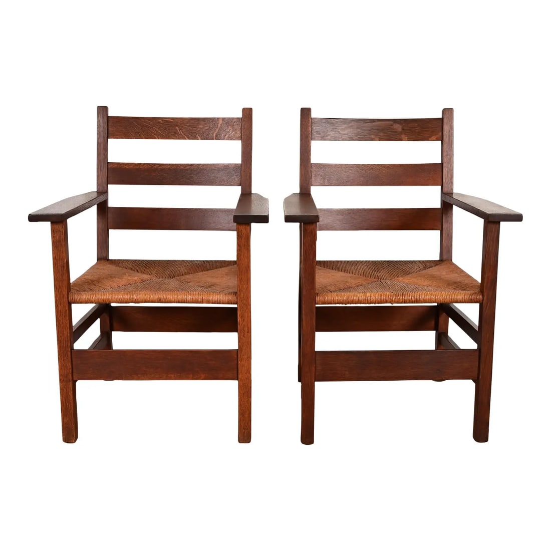 Gustav Stickley Antique Mission Oak Arts & Crafts Ladder Back Armchairs With Rush Seats, Pair: A rare and exceptional pair of Mission or Arts & Crafts period ladder back armchairs, club chairs, or dining captain chairs By Gustav Stickley USA, Early 20th Century Solid quarter sawn oak frames, wi