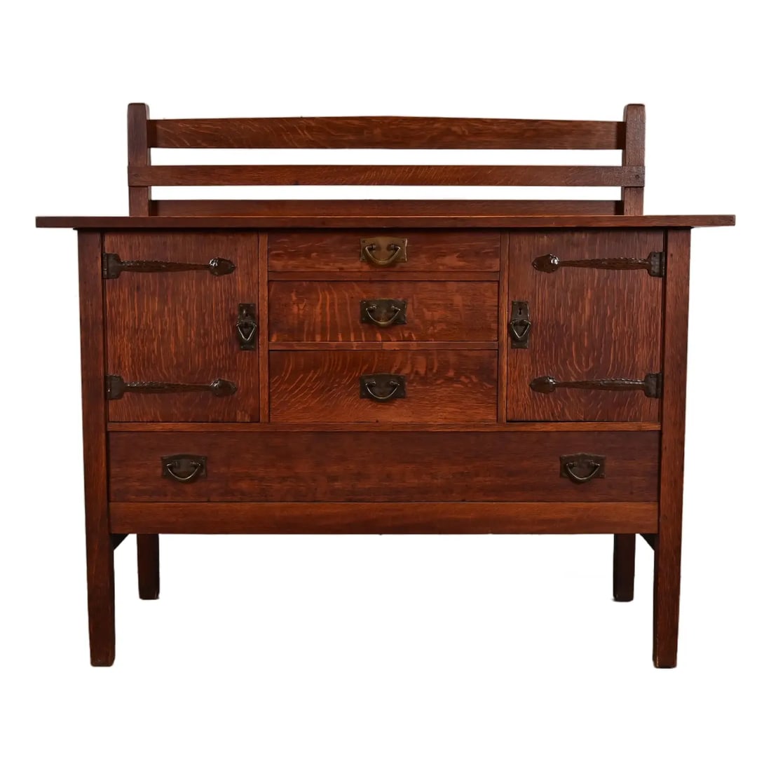 Gustav Stickley Antique Mission Oak Arts & Crafts Strap Hinge Sideboard, Circa 1910: An exceptional antique Mission or Arts & Crafts period strap hinge sideboard, buffet server, or bar cabinet with plate rackBy Gustav StickleyUSA, Circa 1910Quarter sawn oak, with original hammered