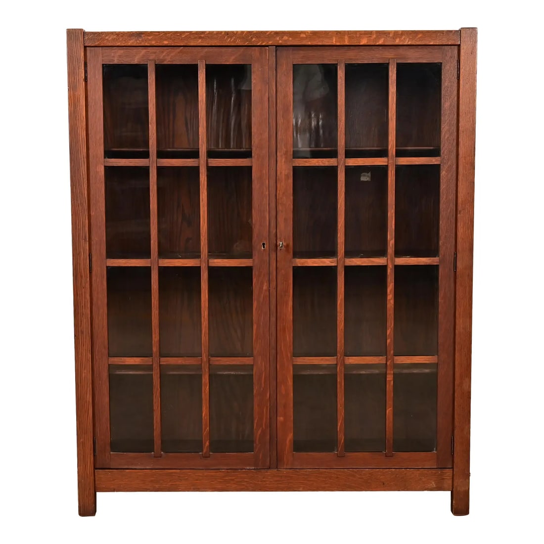 Limbert Style Mission Oak Arts & Crafts Glass Front Double Bookcase Cabinet, Circa 1900: A beautiful Mission or Arts & Crafts period glass front double bookcase cabinet In the manner of Charles P. Limbert Co. USA, Circa 1900 Gorgeous quarter sawn oak, with mullioned glass front doors. Mea