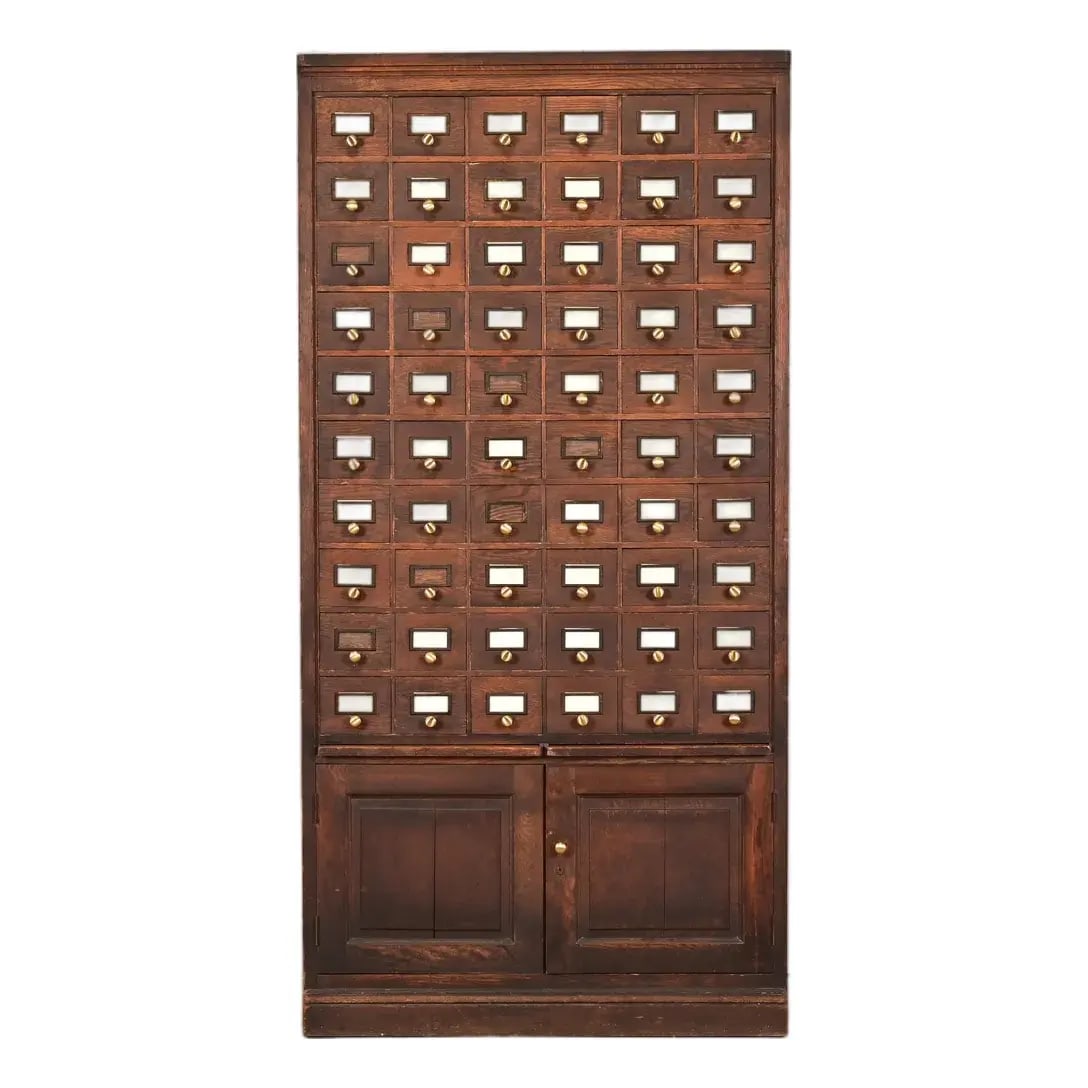 Antique Arts & Crafts Oak 60-Drawer Card Catalog or File Cabinet, Circa 1900: A rare and exceptional antique Arts & Crafts oak 60-drawer card catalog or file cabinet with two pull-out writing tablets In the manner of Globe Wernicke USA, Circa 1900 Solid oak, with original brass