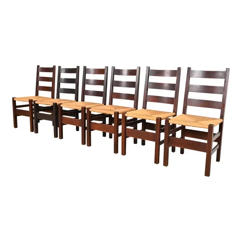 Gustav Stickley Antique Mission Oak Arts & Crafts Ladder Back Dining Chairs With Rush Seats: An exceptional set of six of Mission or Arts & Crafts dining chairs By Gustav Stickley USA, Early 20th Century Solid quarter sawn oak, with rush seats. Measures: 17"W x 18"D x 36"H. Seat height 18". V