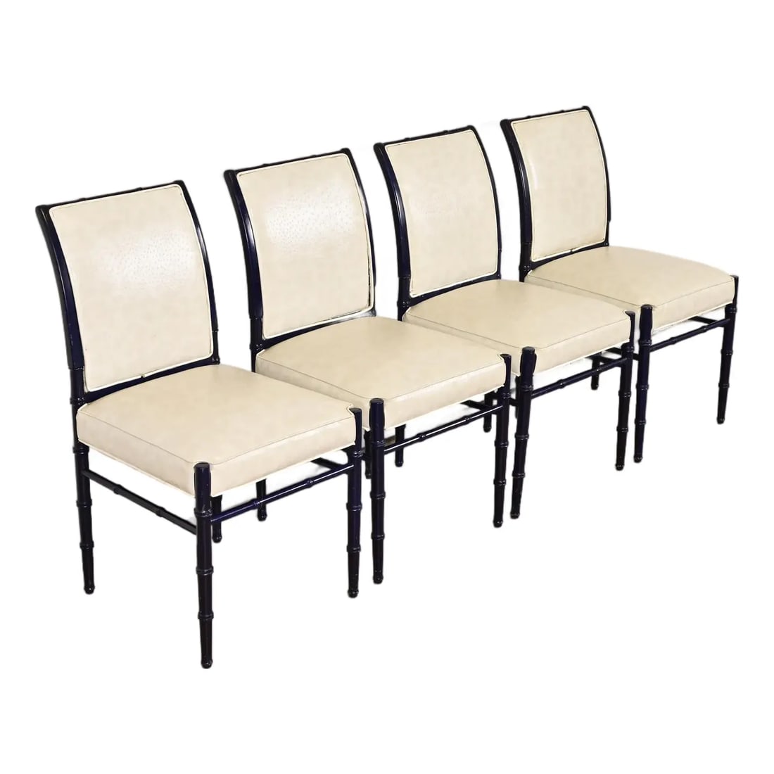 Baker Furniture Style Mid-Century Hollywood Regency Ebonized Faux Bamboo Dining Chairs, Set of Four: A gorgeous set of four mid-century Hollywood Regency side chairs or dining chairs In the manner of Baker Furniture USA, Circa 1970s Ebonized bamboo form walnut frames, with cream vinyl upholstered sea