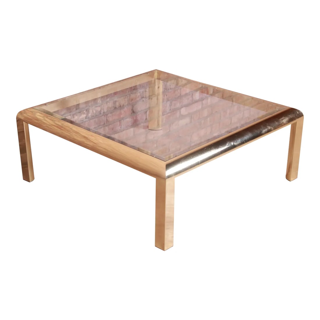 Design Institute of America Modern Hollywood Regency Brass & Glass Cocktail Table, 1984: A gorgeous Milo Baughman style modern Hollywood Regency coffee or cocktail table By the Design Institute of America USA, 1984 Brass frame with beveled glass top. Measures: 38.5"W x 38.5"D x 15"H. Good