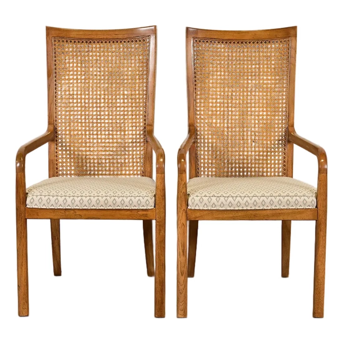 Drexel Heritage Mid-Century Modern Walnut and Cane High Back Armchairs, Pair: A gorgeous pair of Mid-Century Modern high back armchairs or dining captain chairs By Drexel Heritage USA, Circa 1980s Walnut frames, with cane backs and upholstered seats. Measures: 21"W x 22.5"D x 4