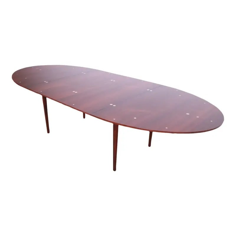 Outstanding Finn Juhl Rosewood and Silver Inlay "Judas" Dining Table, Newly Restored: An extremely rare and exceptional mid-century Danish Modern "Judas" extension dining table. This iconic table was designed by Finn Juhl, expertly produced by cabinetmaker Niels Vodder, and retailed