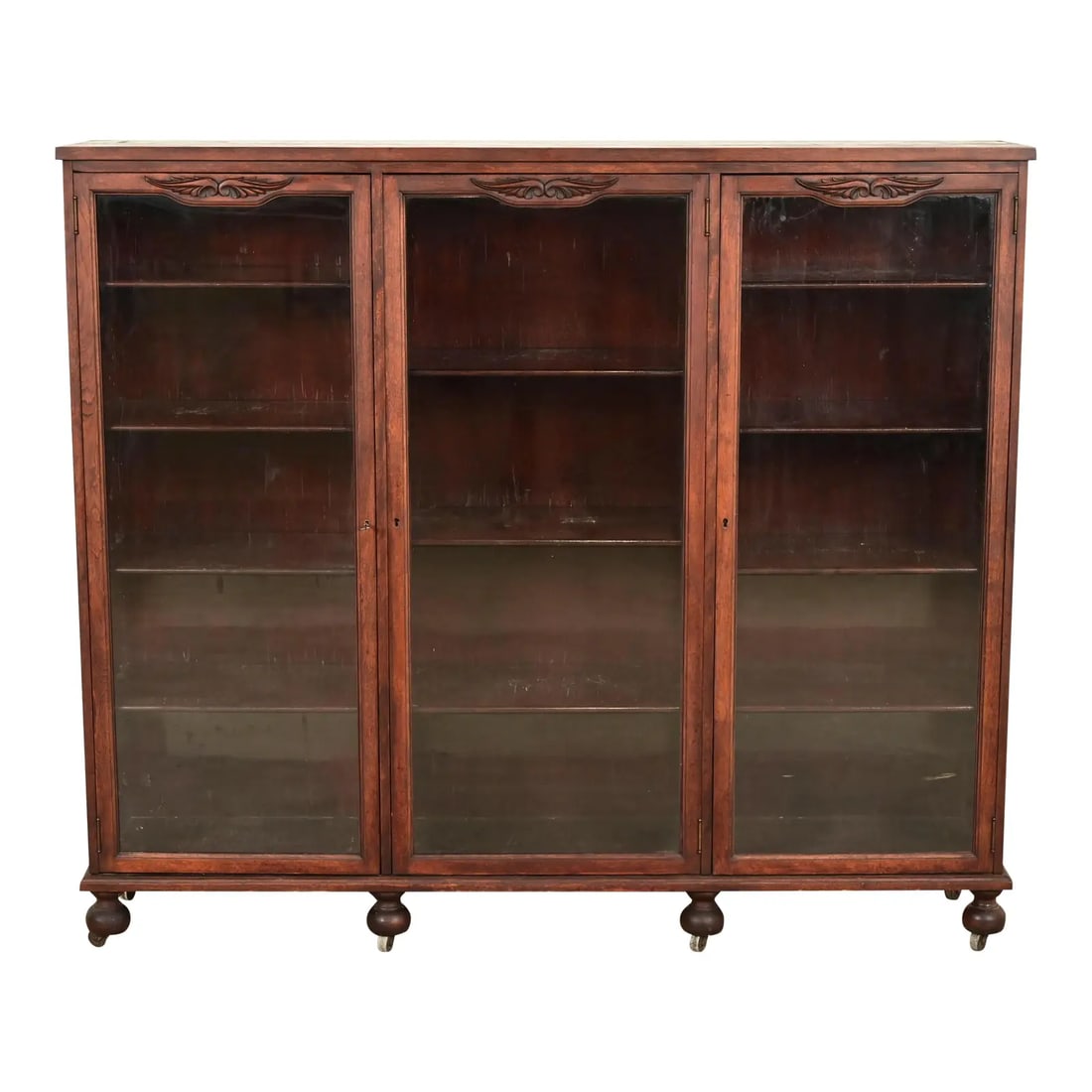 Berkey & Gay Antique Victorian Carved Mahogany Triple Bookcase or Display Cabinet, Circa 1890s: A beautiful antique Victorian, American Empire, or Arts & Crafts triple bookcase or display cabinet By Berkey & Gay USA, Circa 1890s Carved mahogany, with glass front doors. Cabinet locks, and key is