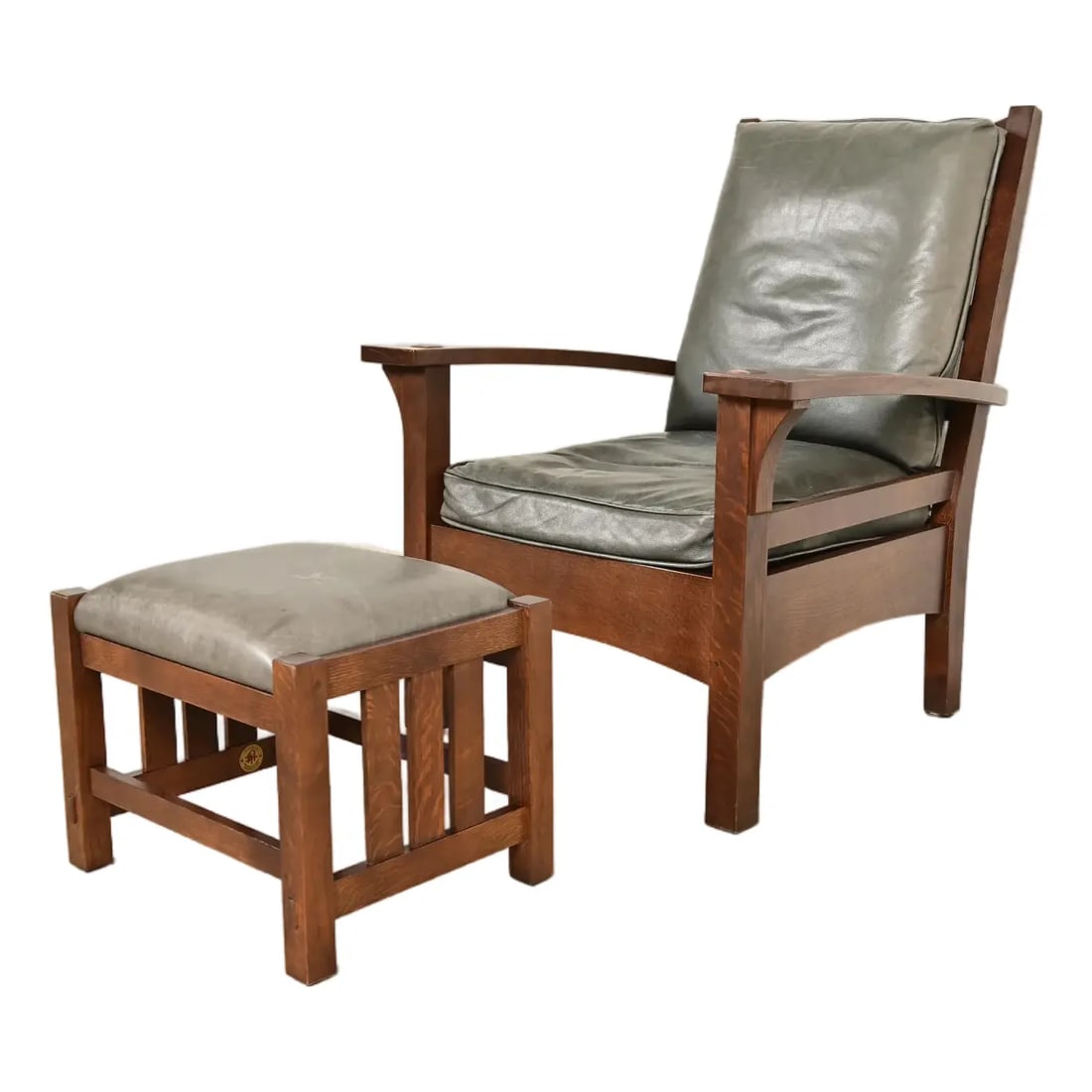 Stickley Mission Oak Arts & Crafts Bow Arm Lounge Chair With Ottoman: An exceptional Mission or Arts & Crafts bow arm lounge chair with ottoman By L. & J.G. Stickley USA, Circa Late 20th Century Solid quarter sawn oak frame, with leather upholstered seat and back cushio