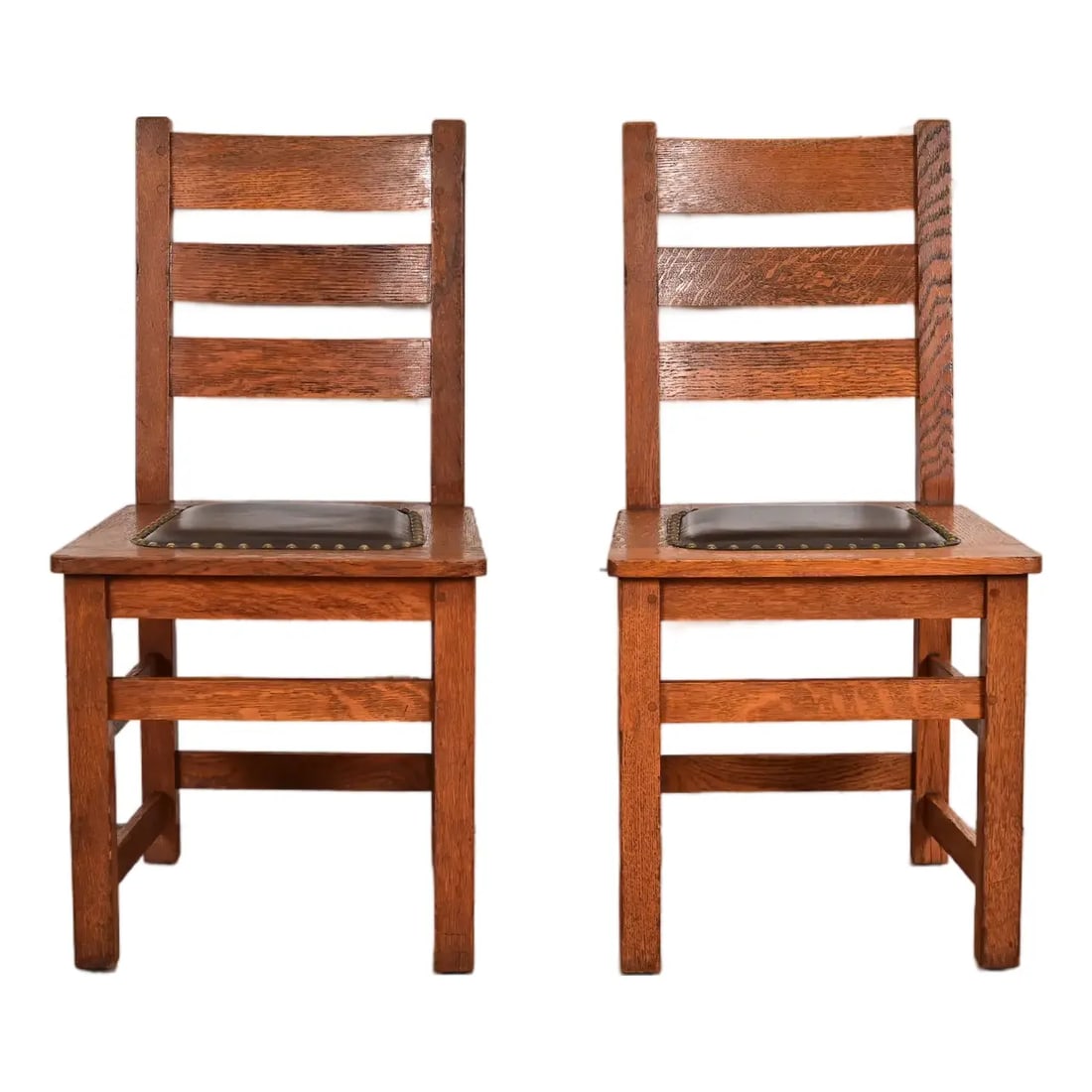 Limbert Antique Mission Oak Arts & Crafts Ladder Back Side Chairs or Dining Chairs, Pair: A beautiful pair of Mission or Arts & Crafts period side chairs or dining chairs By Charles P. Limbert Co. USA, Circa 1910 Solid quarter sawn oak frames, with studded leather upholstered seats. Measur