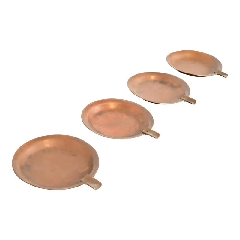 Roycroft Arts & Crafts Copper Ashtrays or Catchalls, Set of Four: A gorgeous set of four Arts & Crafts period copper ashtrays or catchalls By Roycroft (signed with impressed orb and cross mark) USA, Early 20th Century Each measures: 3.5"W x 4.13"D x 0.5"H. Good orig