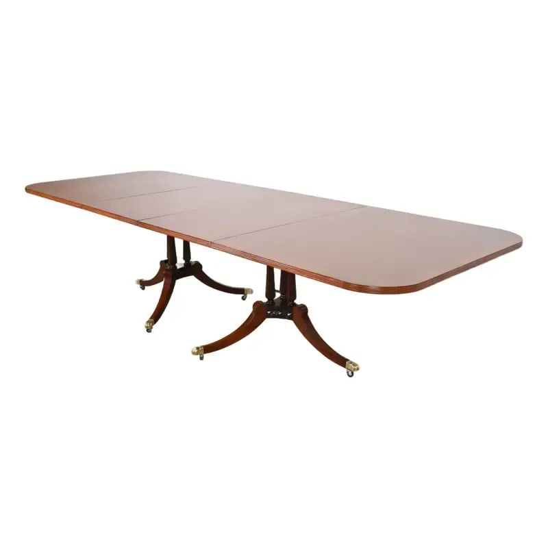 Baker Furniture Style Georgian Banded Mahogany and Rosewood Double Pedestal Extension Dining Table: An exceptional Regency or Georgian style double pedestal extension dining table In the manner of Baker Furniture USA, Circa Mid-20th Century Gorgeous mahogany, with rosewood banding, carved mahogany p