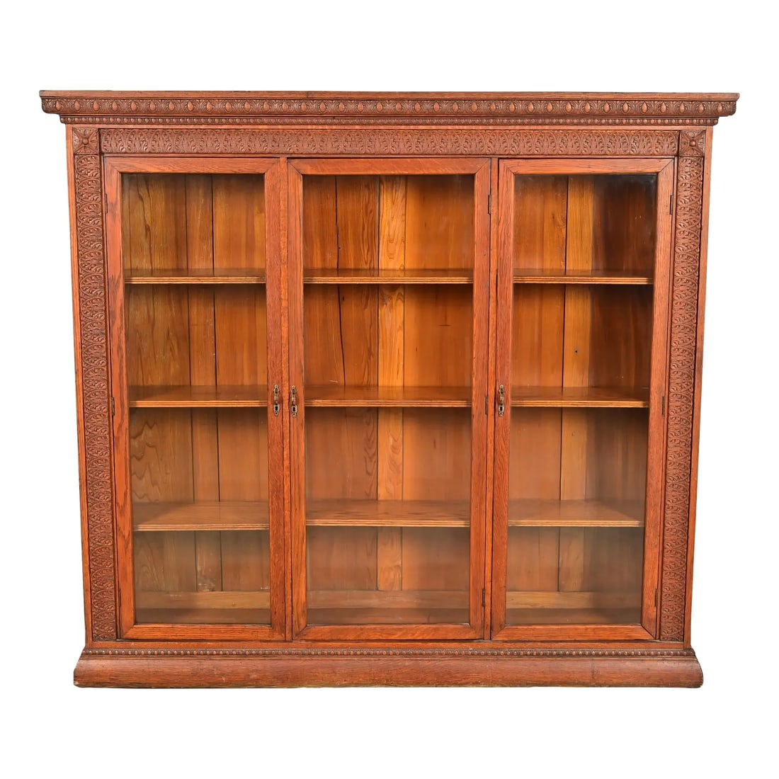 R. J. Horner Style Antique Victorian Carved Oak Triple Bookcase Cabinet, Circa 1880s: A gorgeous antique Victorian or Renaissance Revival triple bookcase In the manner of R.J. Horner & Co. USA, Circa 1880s Carved oak, with glass front doors, and original brass hardware. Measures: 74"W 