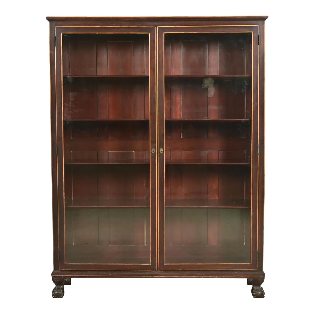 R. J. Horner Style American Empire Carved Mahogany Bookcase With Ball and Claw Feet, Circa 1890s: A gorgeous antique American Empire or Victorian bookcase cabinet In the manner of R.J. Horner & Co. USA, Circa 1890s Mahogany, with satinwood trim, carved ball and claw feet, and glass front doors. Me