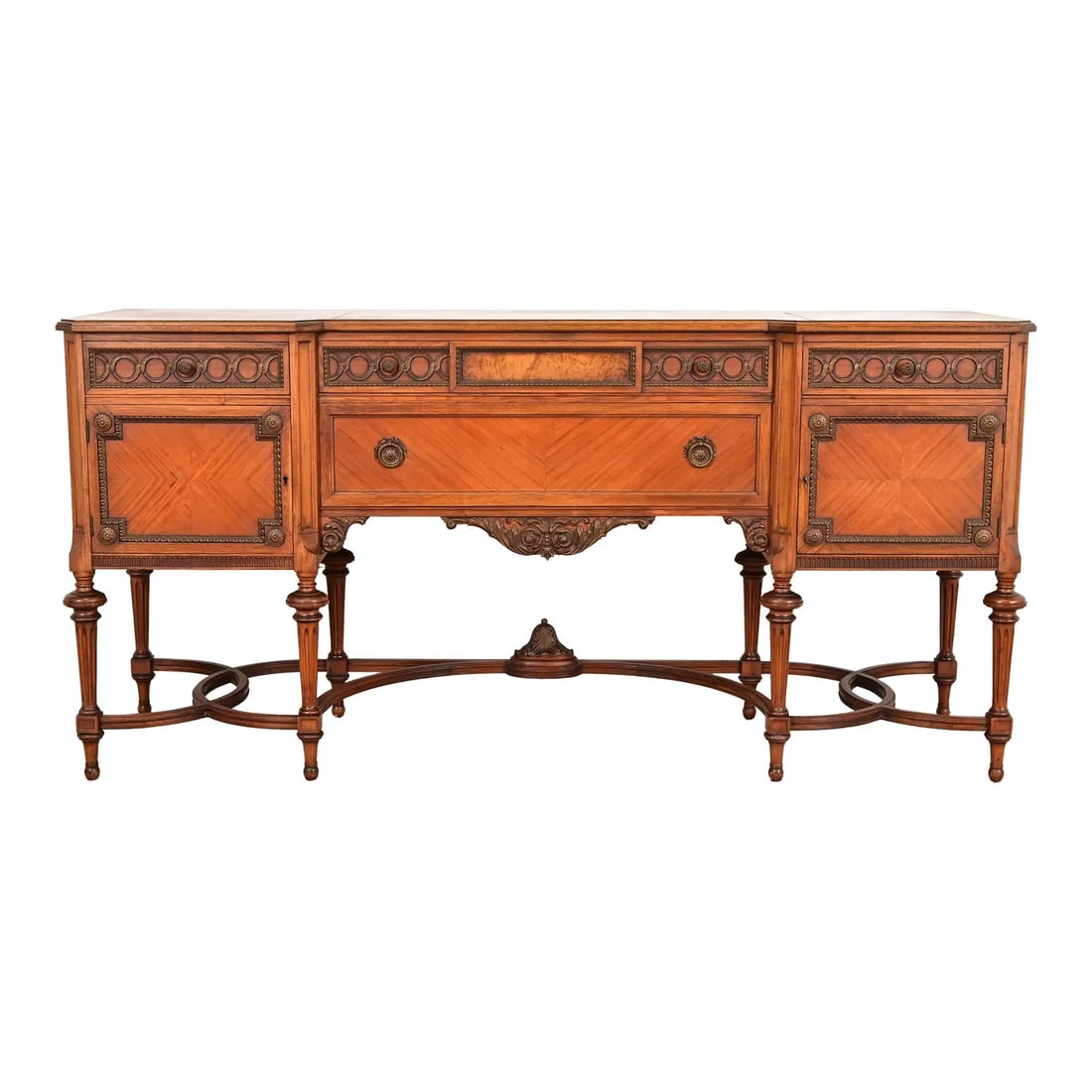 French Regency Louis XVI Carved Walnut and Burl Wood Sideboard by Johnson-Handley-Johnson Furniture: An exceptional antique French Regency Louis XVI style sideboard, credenza, or bar cabinet By Johnson-Handley-Johnson Co. USA, Circa 1920s Carvel walnut case, with burl wood and satinwood panels, and o