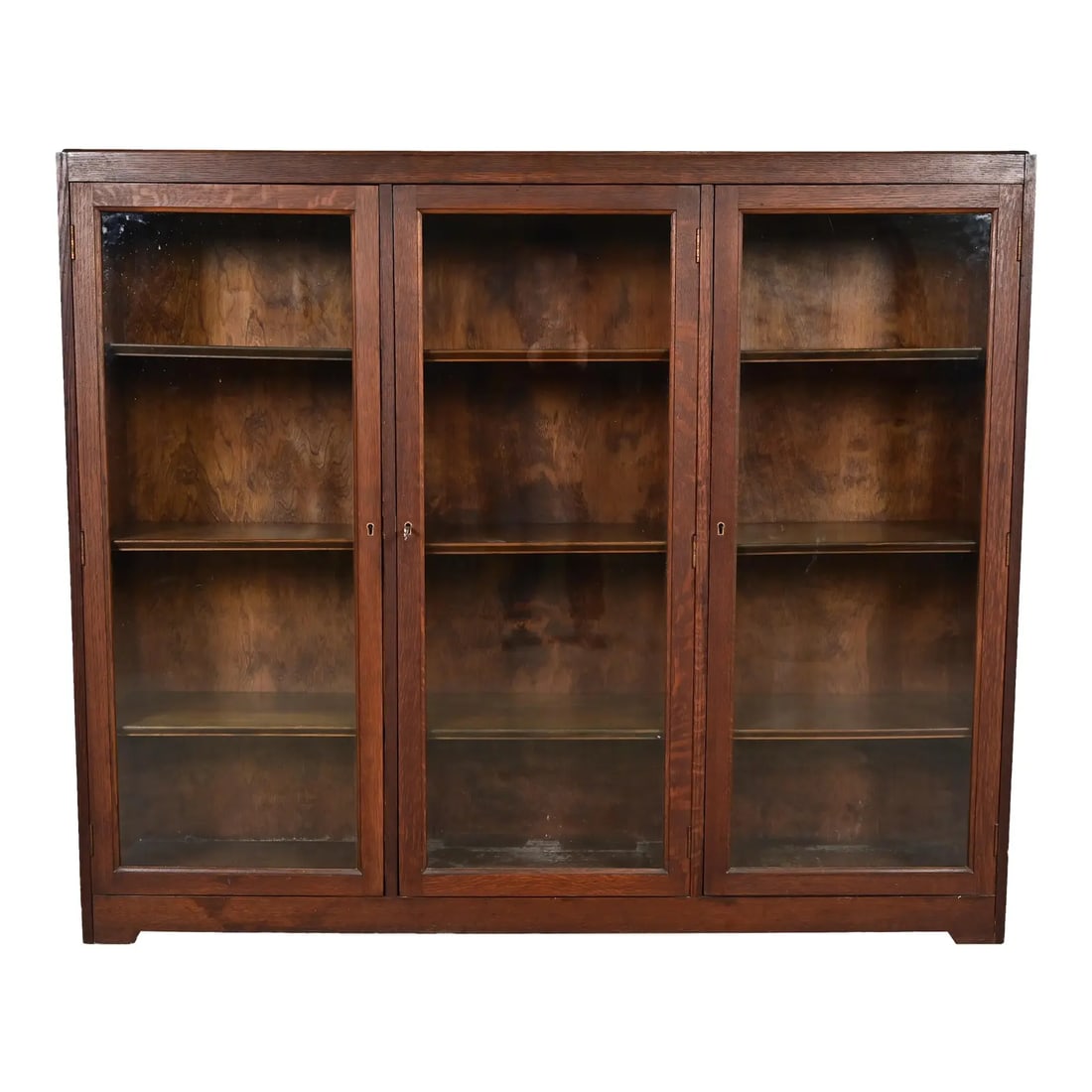 Limbert Style Antique Mission Oak Arts and Crafts Triple Bookcase Cabinet, Circa 1900: A beautiful antique Mission or Arts & Crafts period triple bookcase cabinet In the manner of Charles P. Limbert Co. USA, Circa 1900 Quarter sawn oak, with glass front doors. Interior shelves are adjus